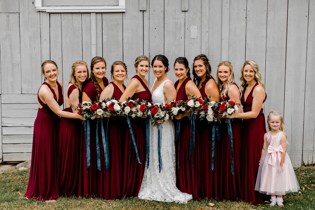 Bridal party smiling holding bouquets