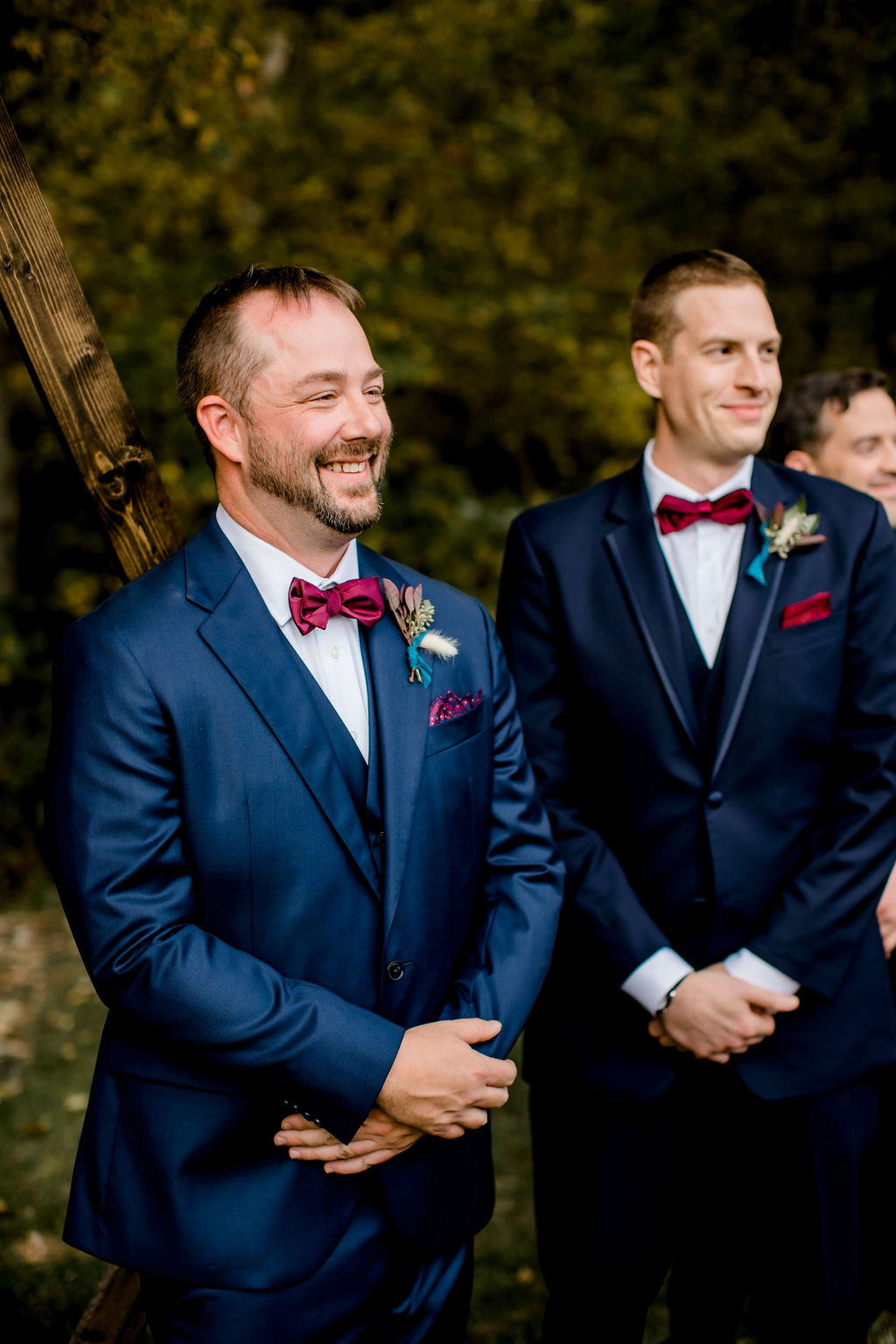 Groom smiling at his bride walking down aisle