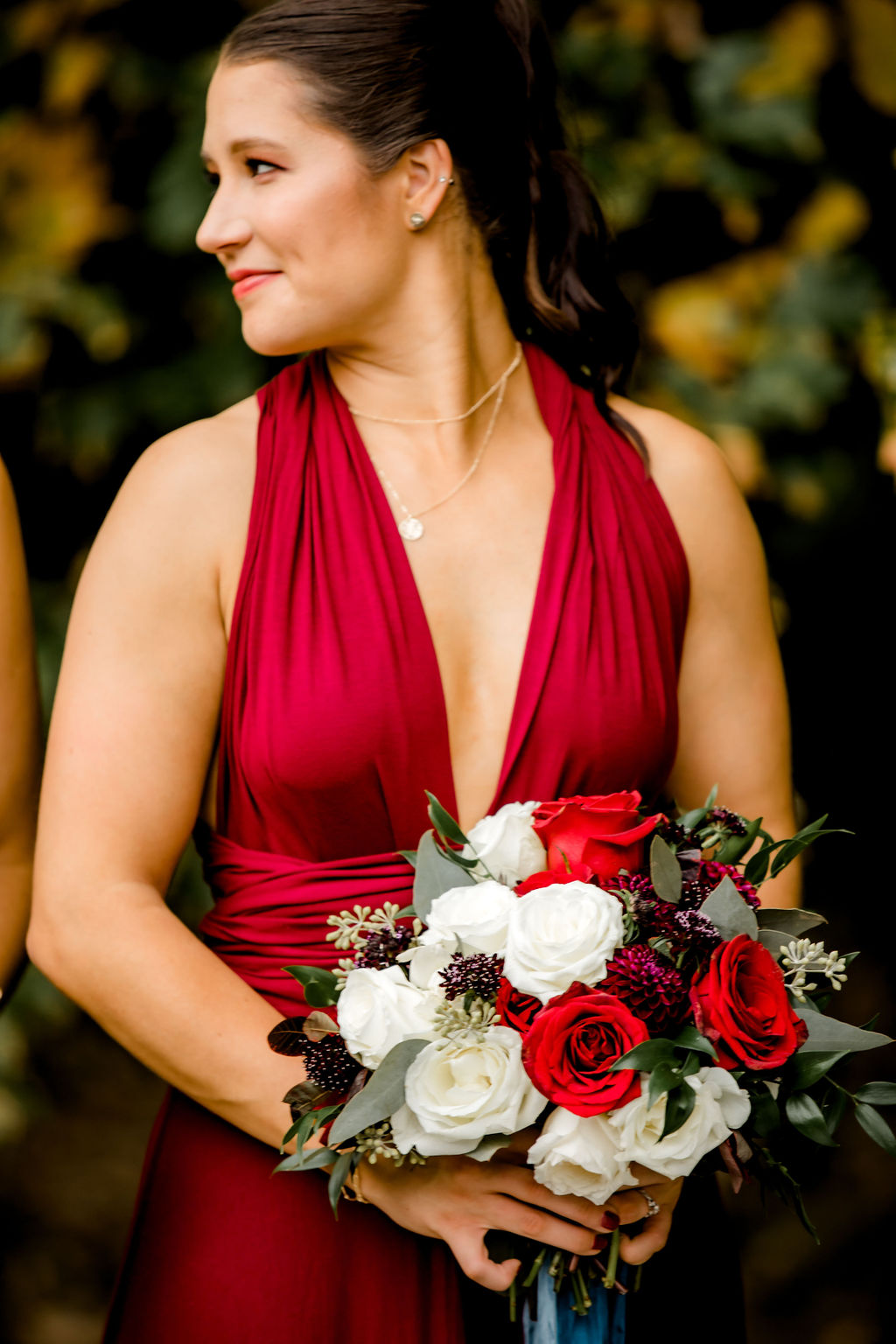 Bridesmaid smiling holding her bouquet