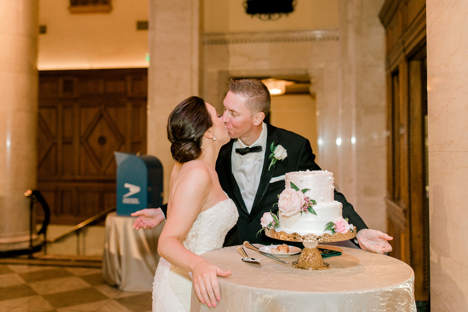 Bride and groom kissing after cake cutting