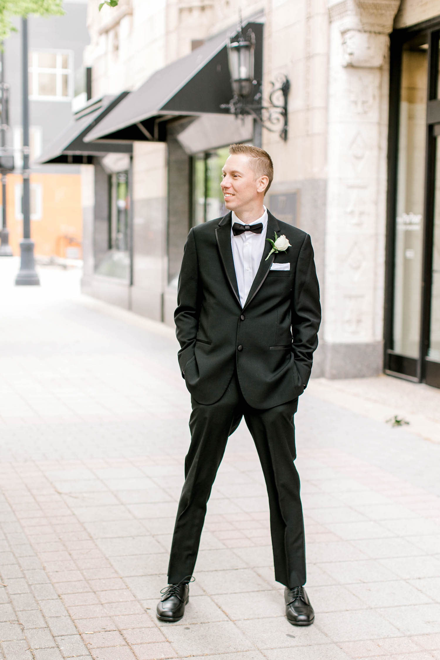 Groom standing on sidewalk