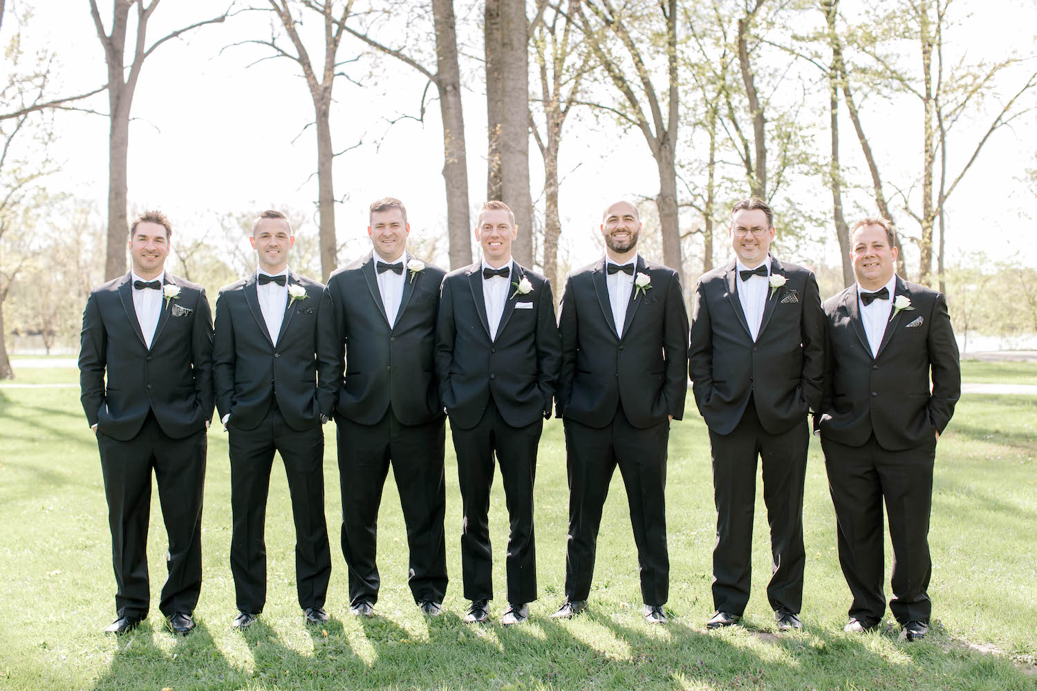 Groom standing with groomsman outside