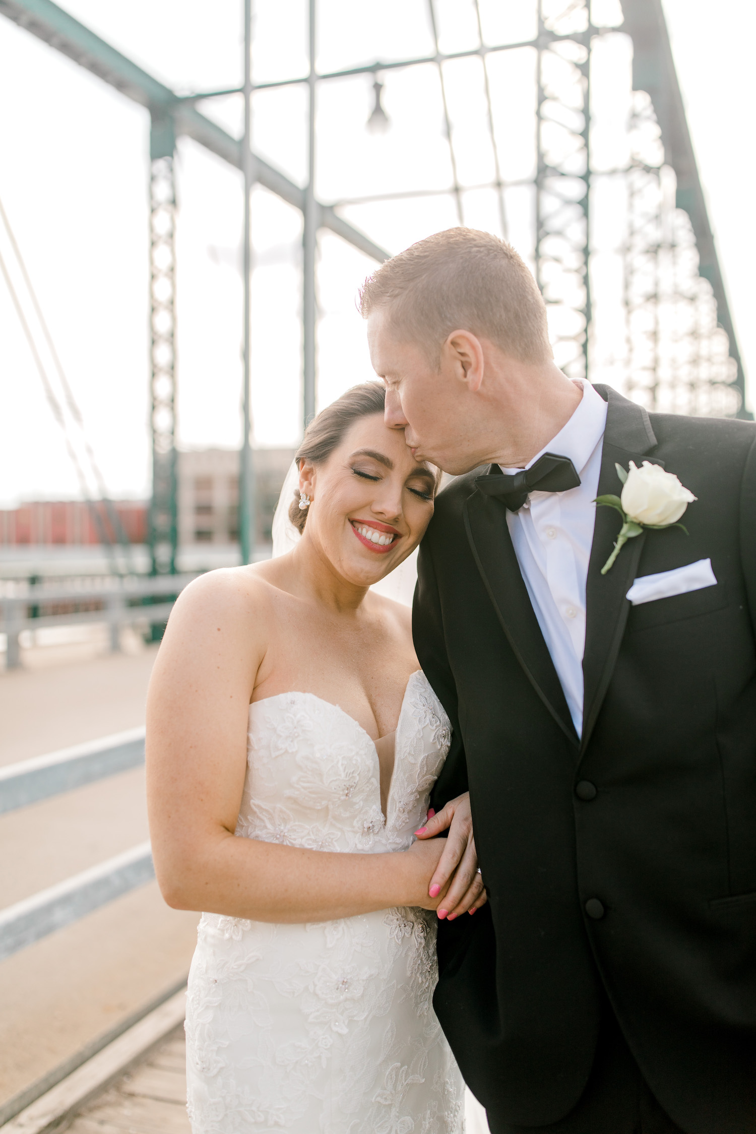 Groom kissing his brides head