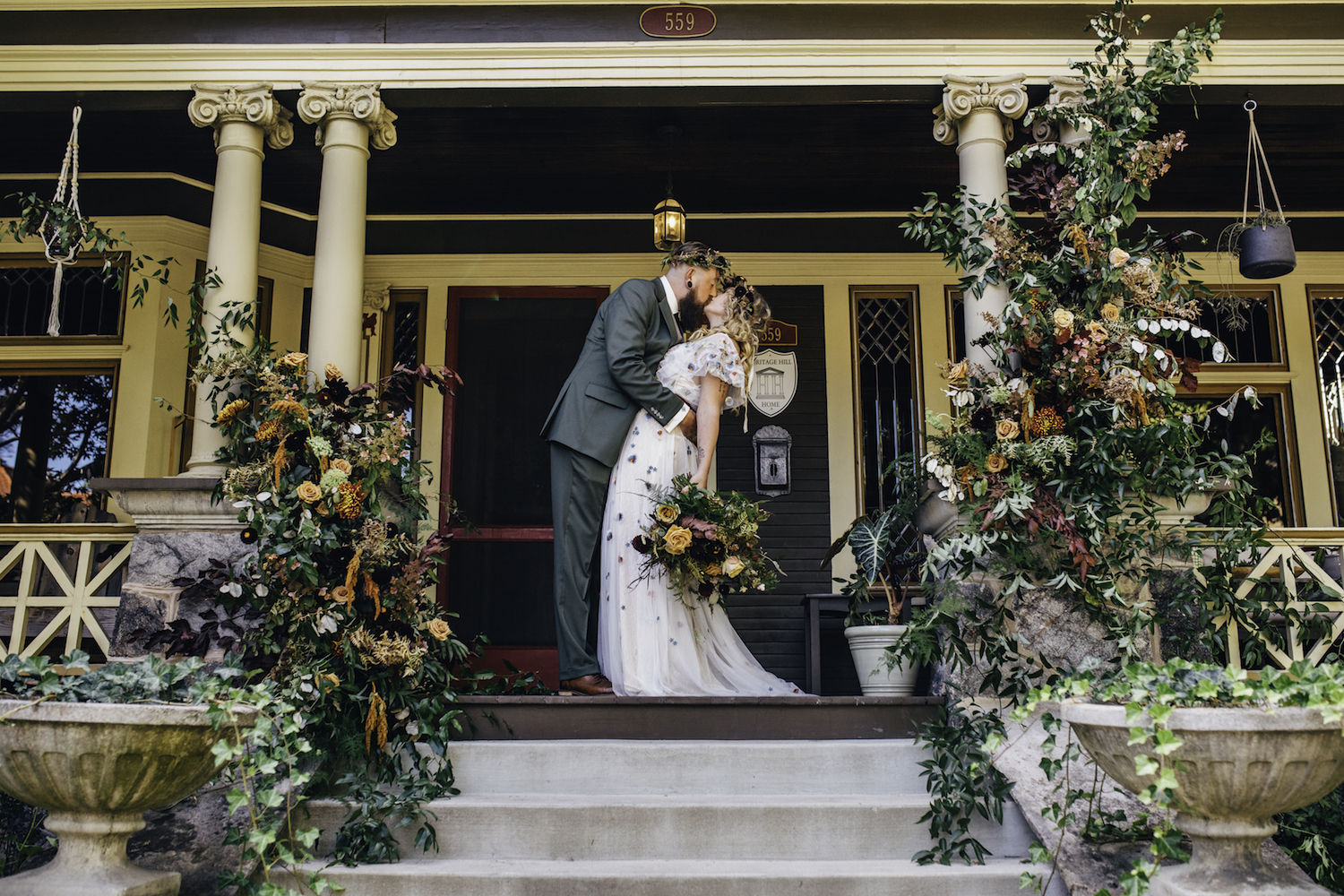 Groom kissing his bride on front porch