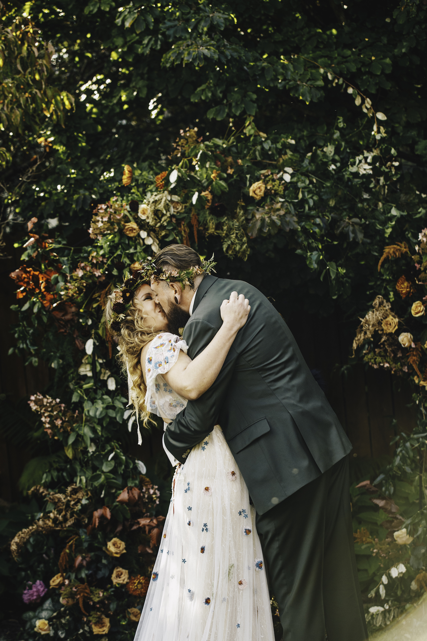 Bride and groom kiss after ceremony of Grand Rapids Backyard wedding