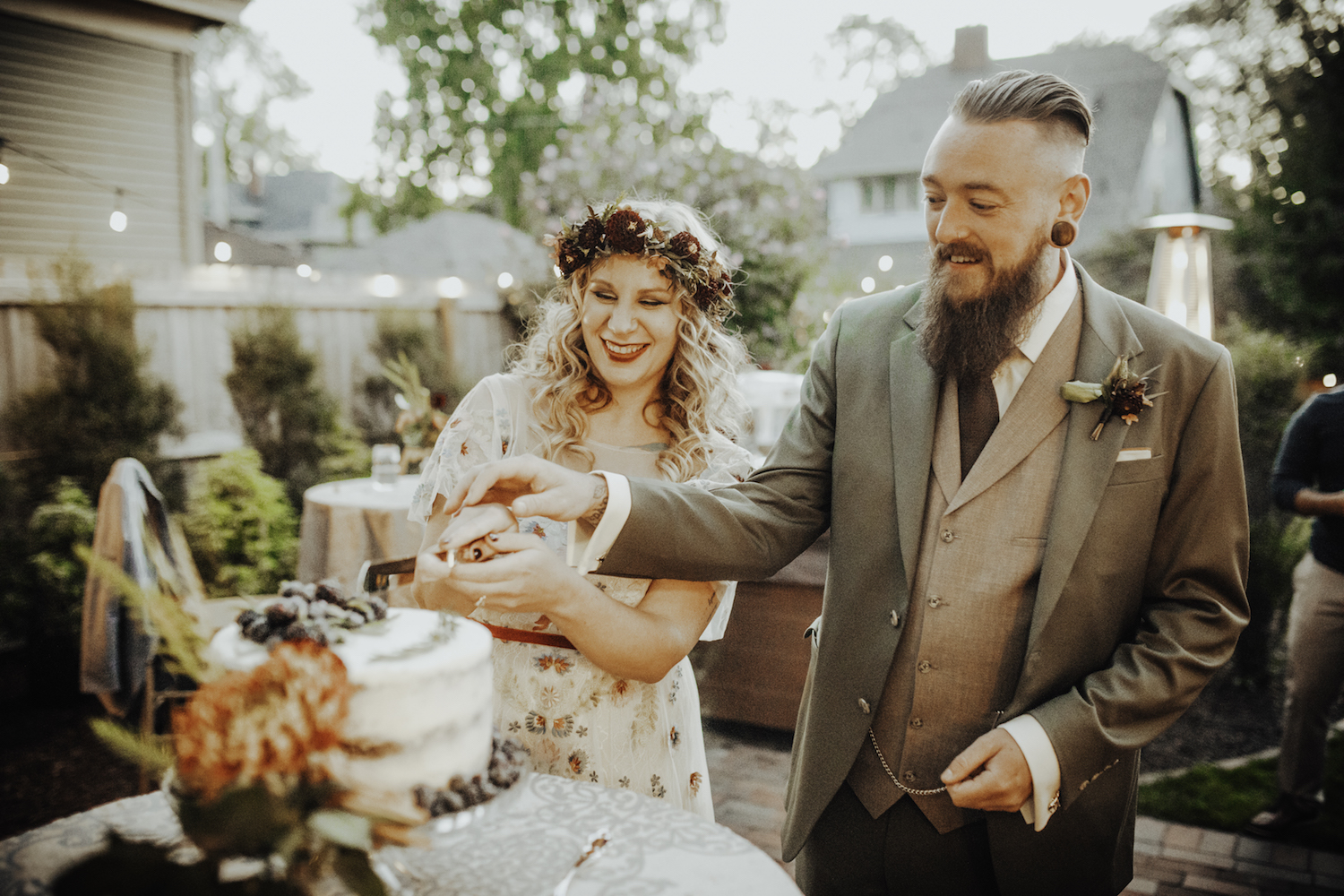 Bride and groom cutting their cake at their Grand Rapids Backyard wedding