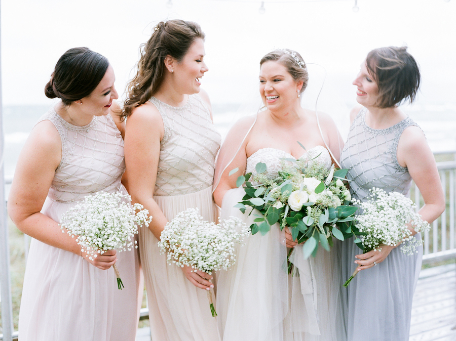 Bride and bridesmaids smiling before a camp blodgett wedding