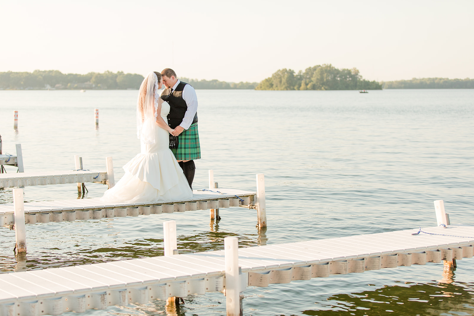 Bride and groom smiling at sunset during their Bay Pointe Inn wedding in Shelbyville, Michigan