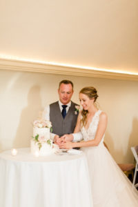 Bride and groom cutting the cake at their felt mansion wedding