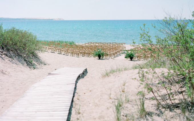 A ceremony set up on the beach of Lake Michigan and a blog post talks about all the wedding dos from this wedding day