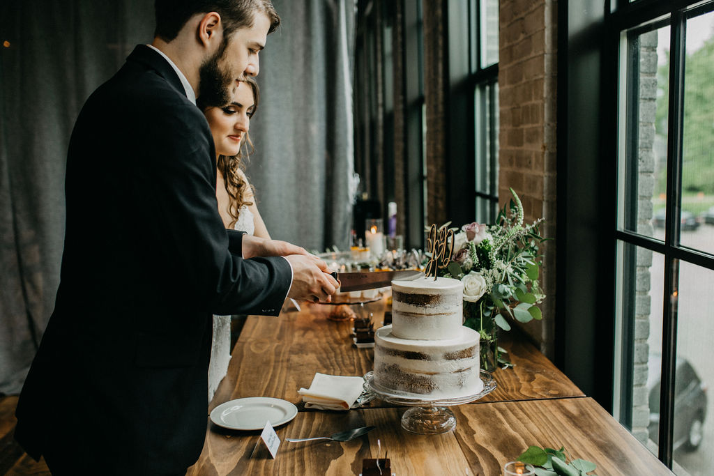 A couple cutting their wedding cake