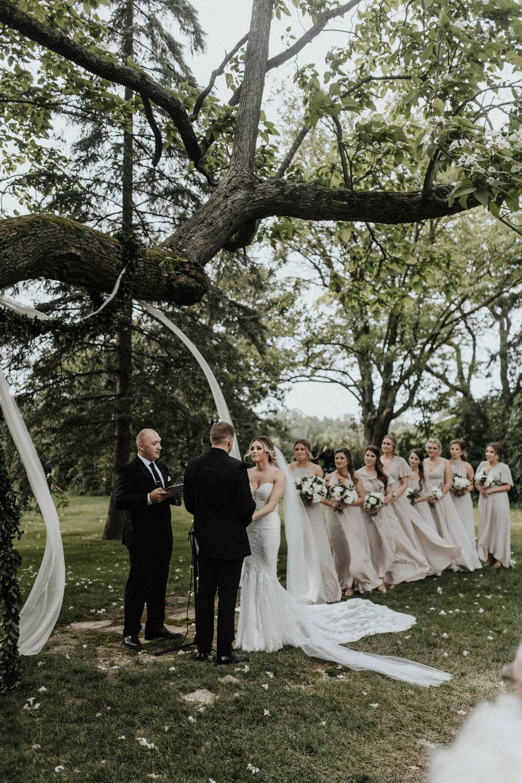 An outdoor ceremony during a Hidden Vineyard Wedding Barn wedding.