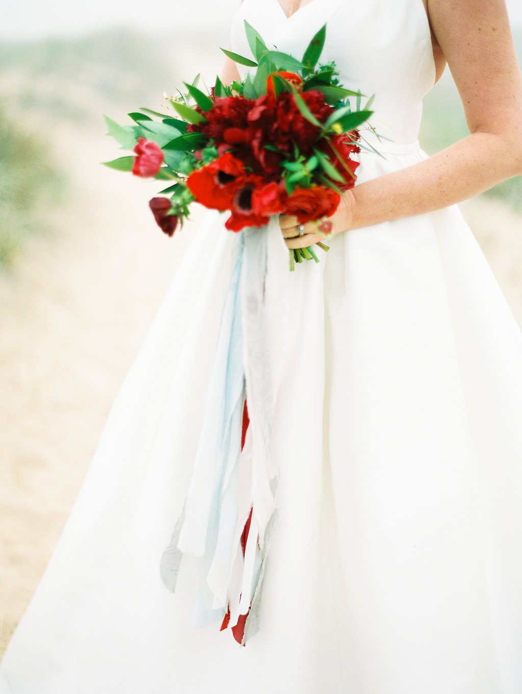 Bride holding a bouquet during her Lake Michigan beach wedding