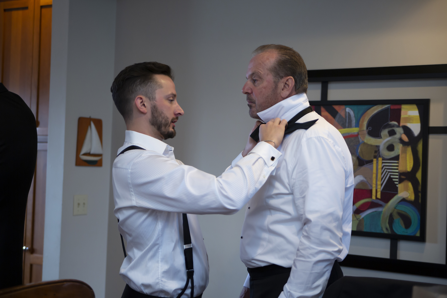 Groom tying Father of bride's tie