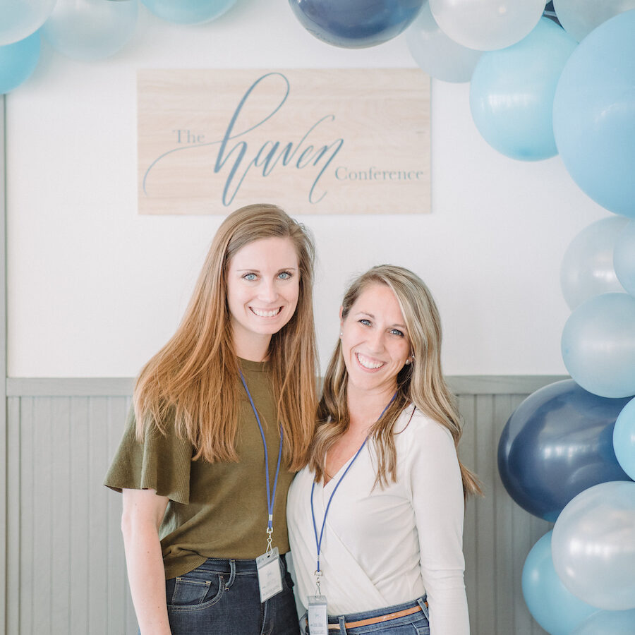 Attendees smiling under a balloon arch at a Michigan entrepreneur conference